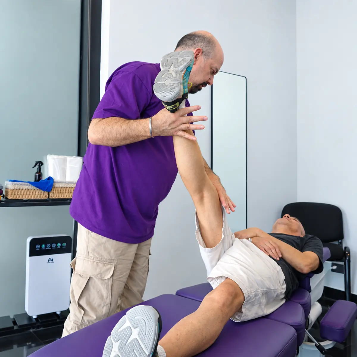 Dr. Steven Poppaw assessing a patient's hip and leg movement