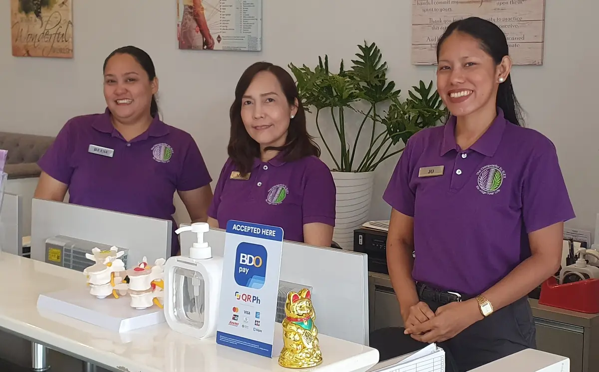 The Purple Ladies clinic team at the reception desk in Southwoods Mall, Biñan